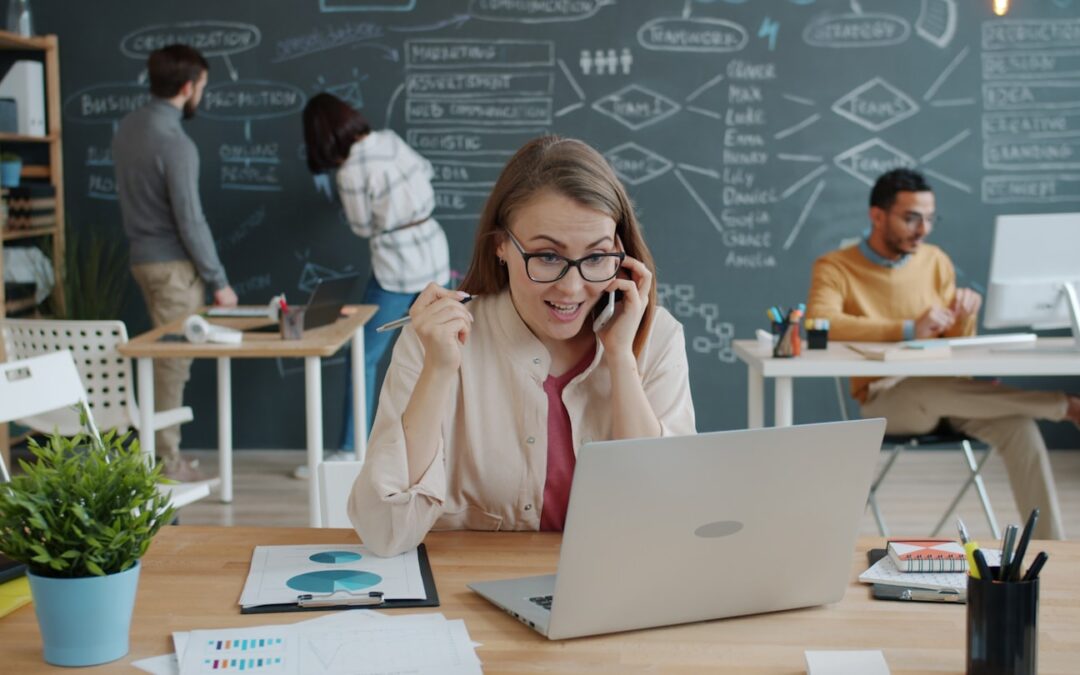 Woman celebrating success while on a business call.
