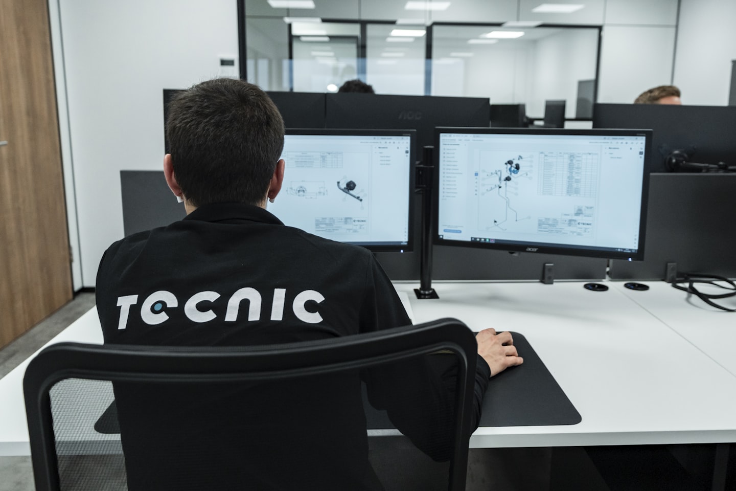 A person works on a computer in an office