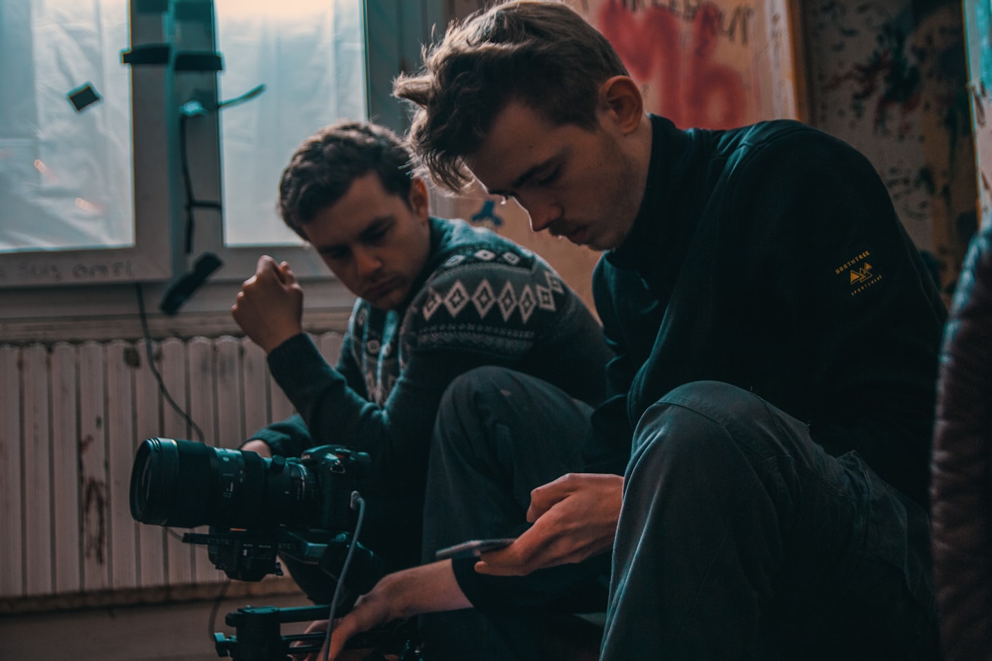 man in black jacket sitting beside man in black jacket