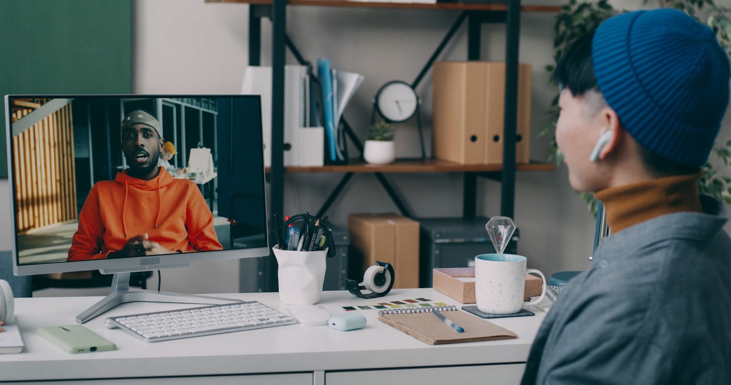 A person sitting at a desk with a computer