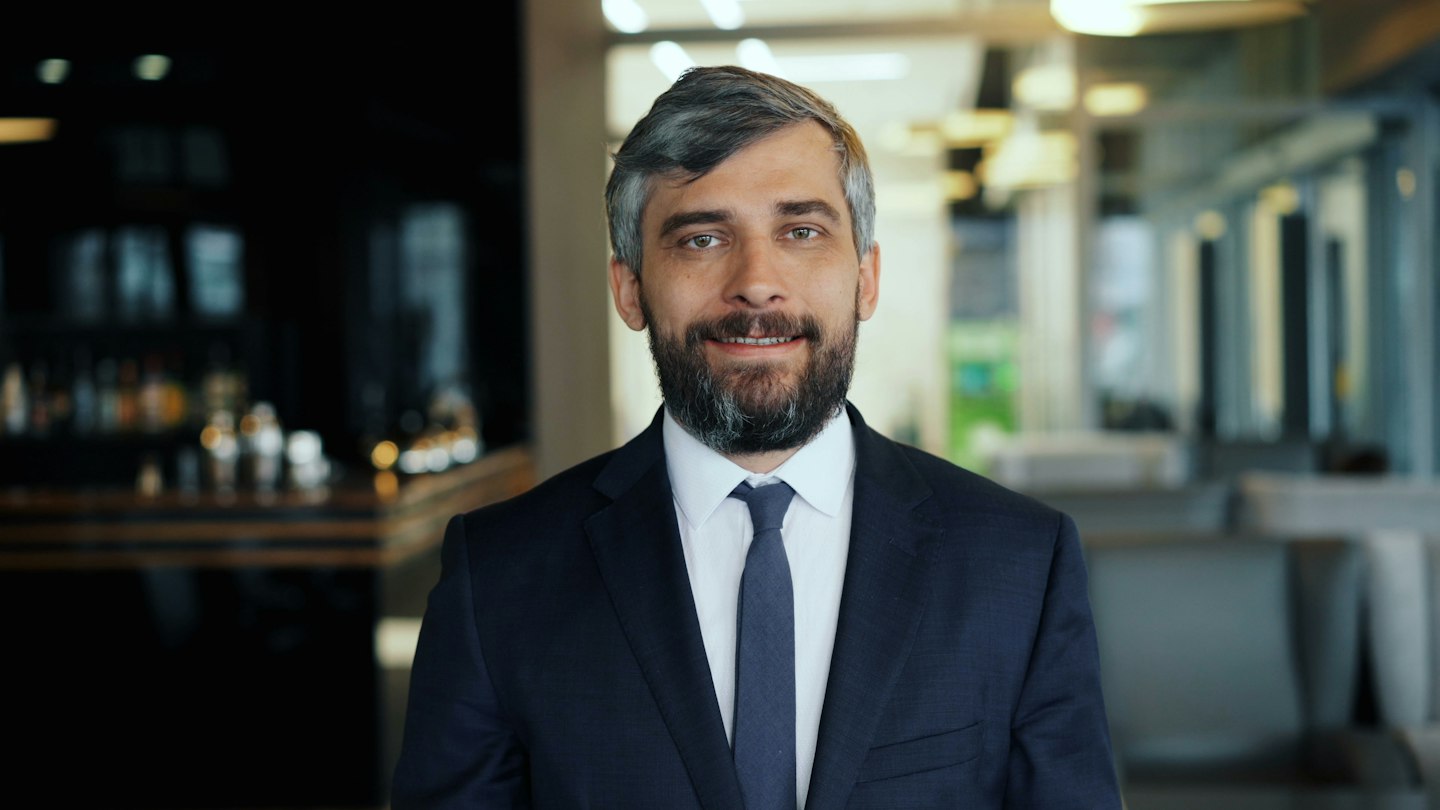 a man in a suit and tie standing in a room