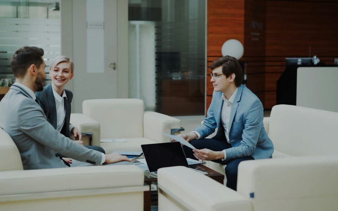 Three professionals in a modern office lounge