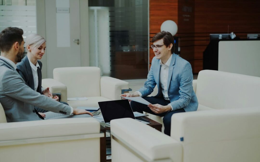 Three business people in a modern office meeting