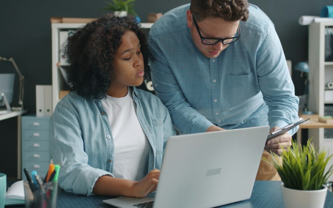 Two colleagues collaborating on a project at a desk