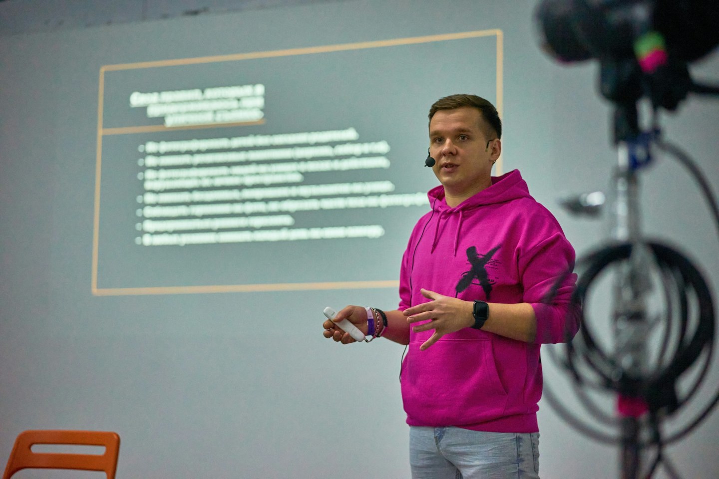 A man standing in front of a projection screen